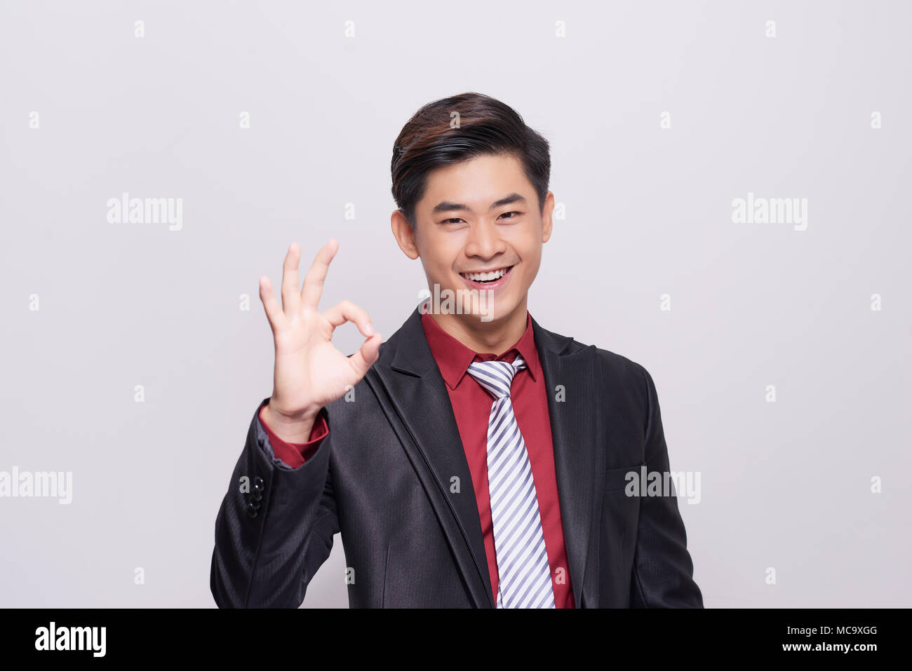 Young asian Business Man with OK hand gesture Stock Photo