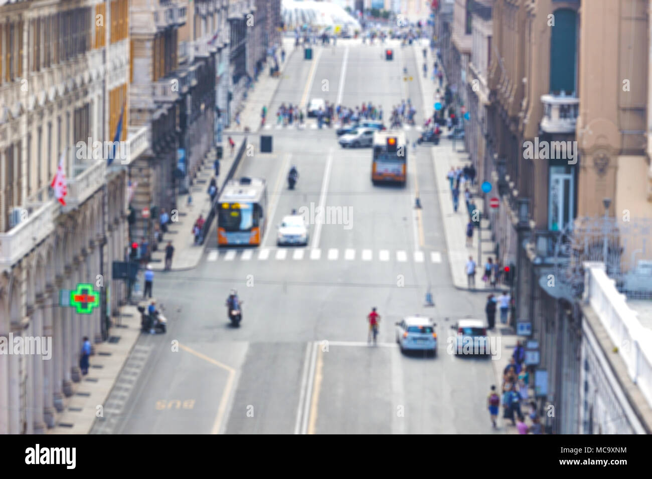 Blurred image of people and traffic moving in crowded city street. Art toning abstract urban background. Crowd of traffic anonymous people walking on  Stock Photo