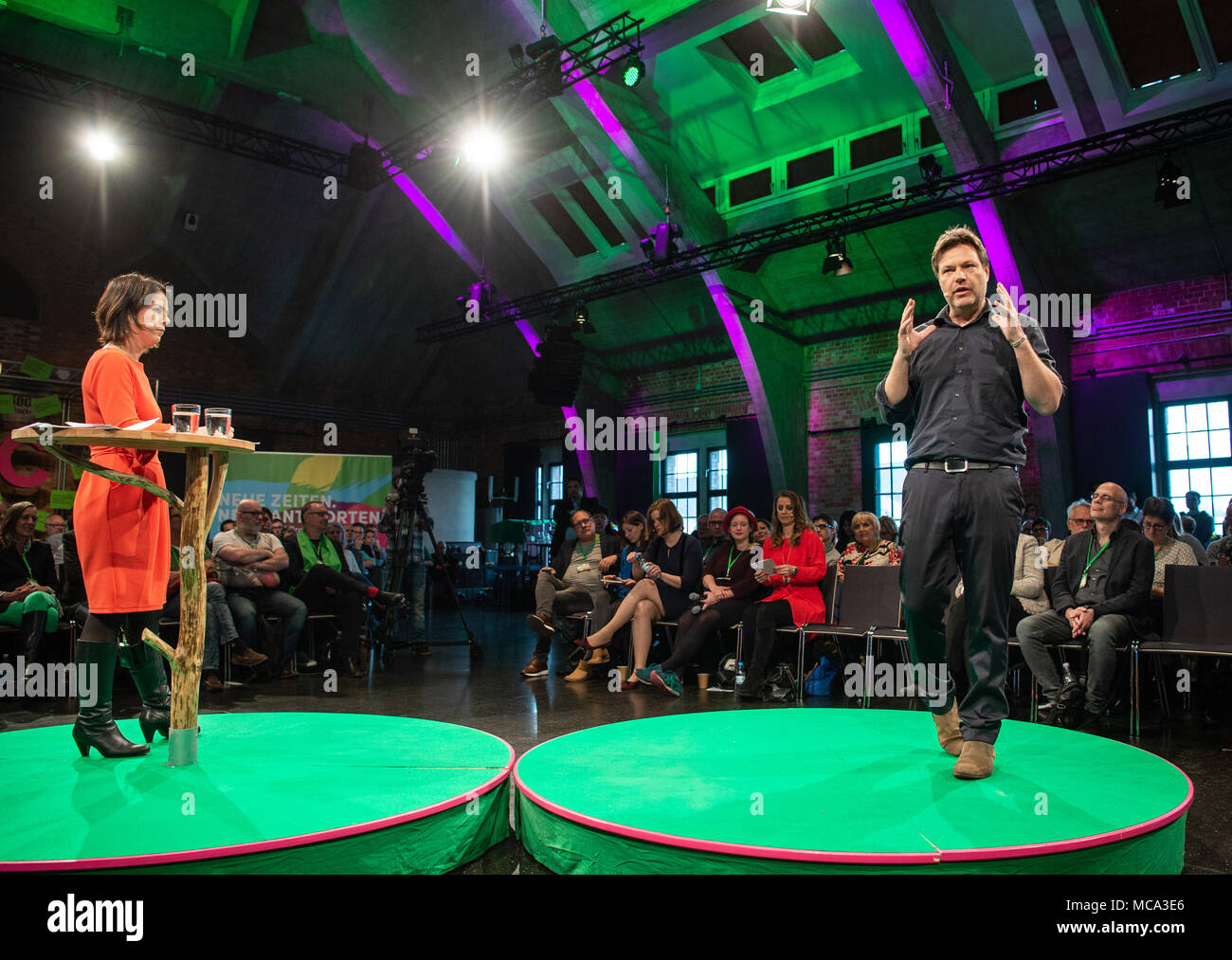 13 April 2018, Germany, Berlin: Annalena Baerbock and Robert Habeck, the chairmen of the German party Alliance 90/The Greens, speak during the opening of the work on their new policy programme. The 'Start Convention' runs under the motto 'Neue Zeiten. Neue Antworten' (lit. new times. new answers). The policy programme is supposed to be completed by spring 2020. Photo: Christophe Gateau/dpa Stock Photo