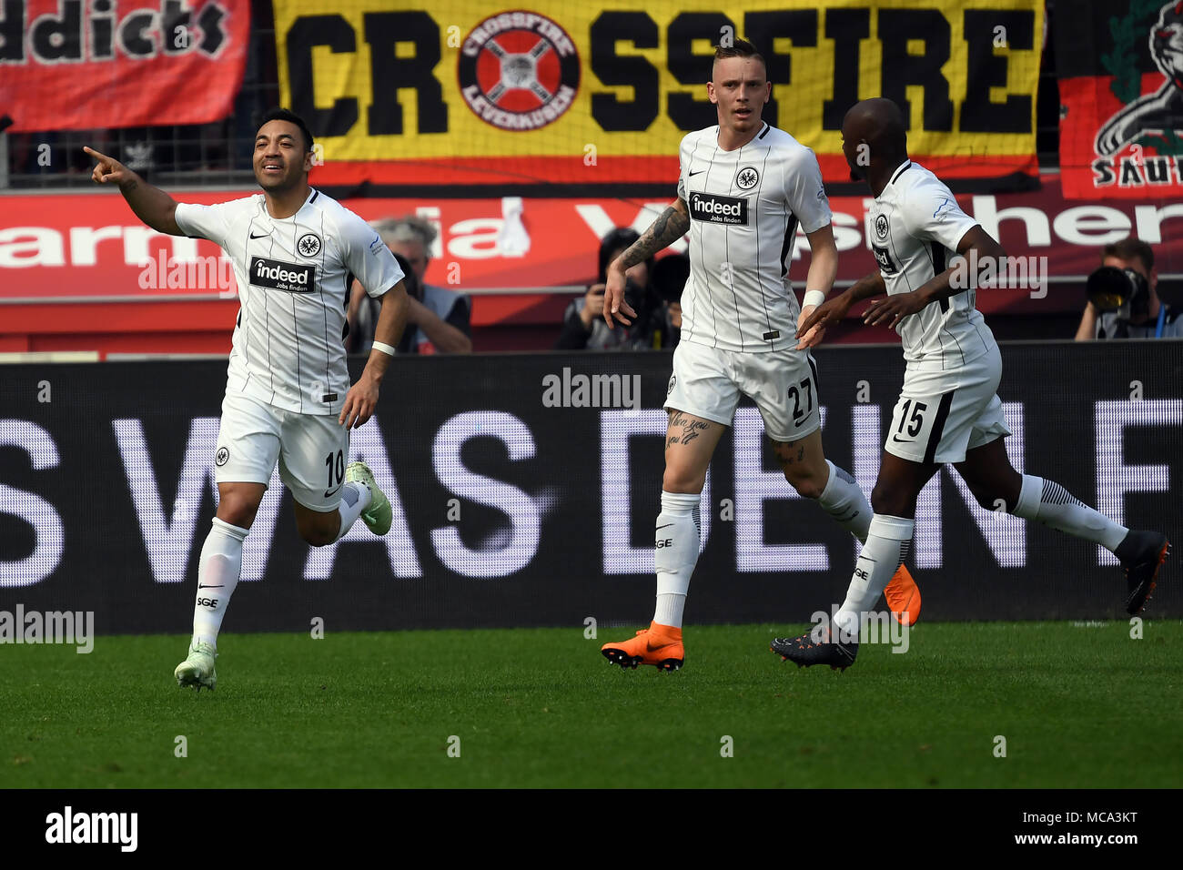 14 April 2018, Germany, Leverkusen: Soccer, Bundesliga, Bayer Leverkusen vs Eintracht Frankfurt at the BayArena: Frankfurt's goal scorer Marco Fabian (L-R), Marius Wolf and Jetro Willems celebrate the 1-1 goal. Photo: Federico Gambarini/dpa - ATTENTION: Due to the accreditation guidelines, the DFL only permits the publication and utilisation of up to 15 pictures per match on the internet and in online media during the match. Stock Photo