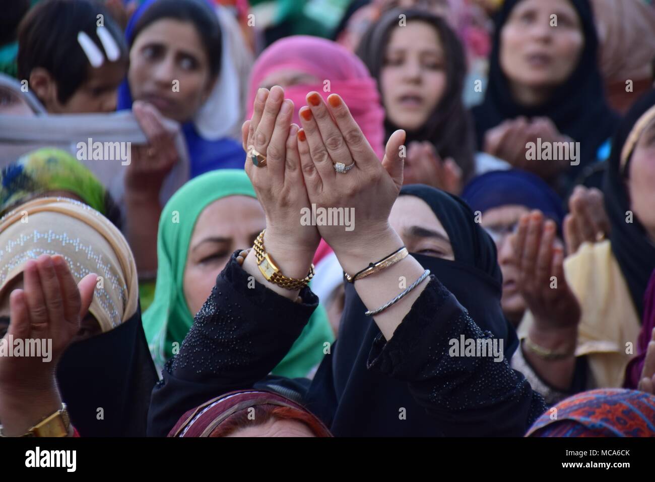 Kashmiri Muslim Devotees beseech for blessings as holy relic is being displayed on the occasion of Mehraj-ul-Alam at Dargah Hazratbal in Srinagar, summer capital of Indian Kashmir. Every year thousands of Muslim devotees from across Kashmir gathers at Hazratbal shrine in central Srinagar summer capital of Indian Kashmir for prayers and to watch the Holy Relic (moe-e-moqadas) believed to be a hair from the beard of Prophet Mohammed PBUH, displayed for public on Meraj-ul Alam and other festivals. Mehraj-ul-Alam, A festival which marks the ascension Of Prophet Muhammad PBUH To Heaven. Stock Photo