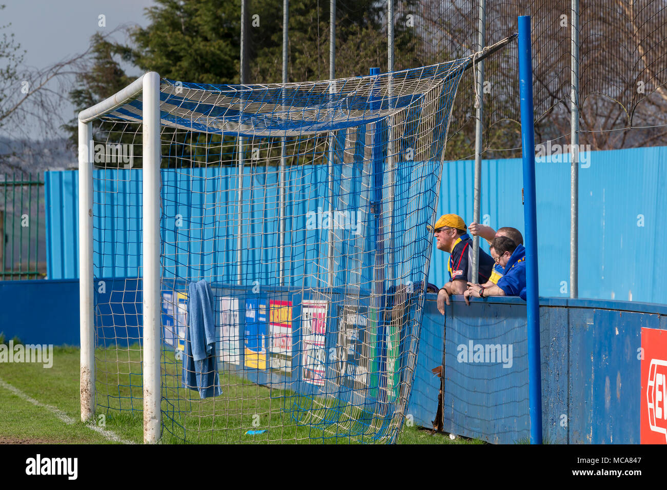 Three Warrington Town supporters stand behind the goal at Throstle Nest, Farsley during the match between Warrington Town FC and Farsley Celtic on 14 April 2018 where Warrington won 2 - 0 Credit: John Hopkins/Alamy Live News Stock Photo