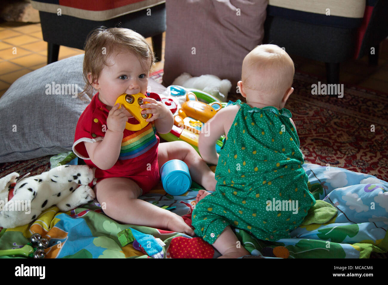 Babies playing with their toys Stock Photo Alamy