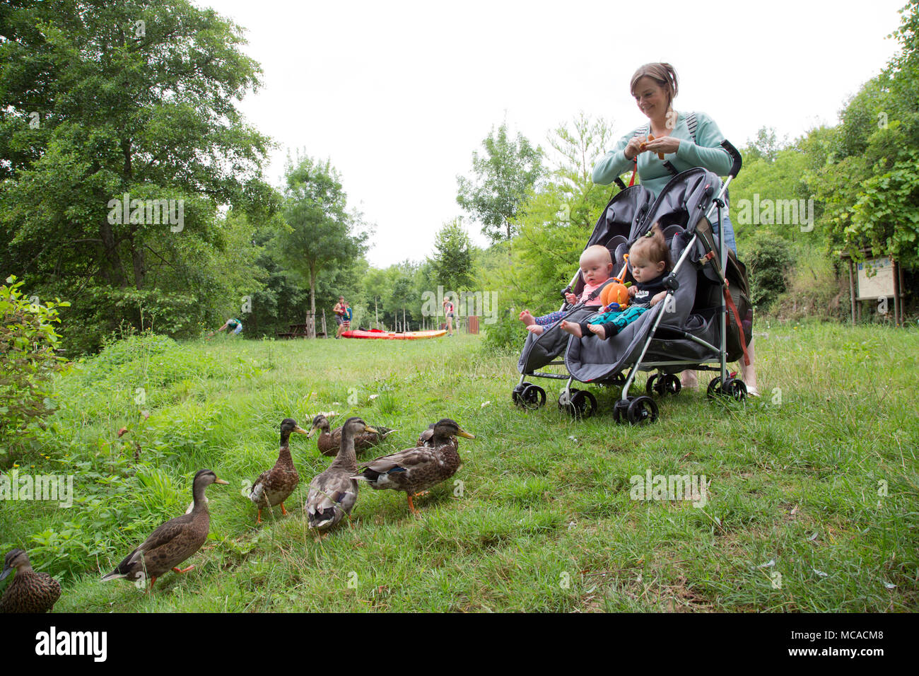 Young mum pushing a double buggy on holiday with twins Stock Photo Alamy