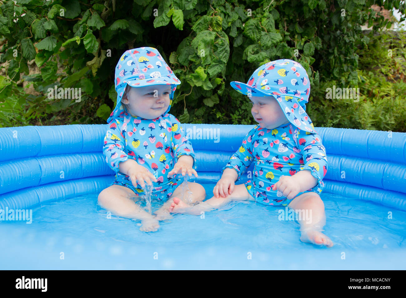 Babies plating in a paddling pool Stock Photo Alamy