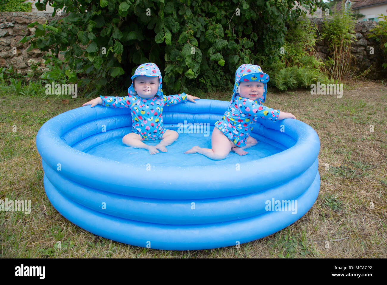 Babies plating in a paddling pool Stock Photo Alamy