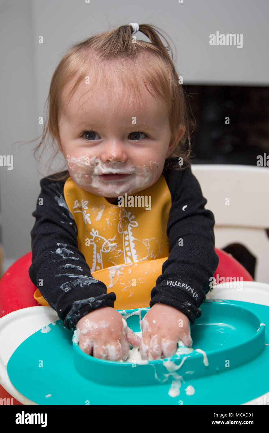 9 month old baby eating yoghurt baby led weaning Stock Photo Alamy