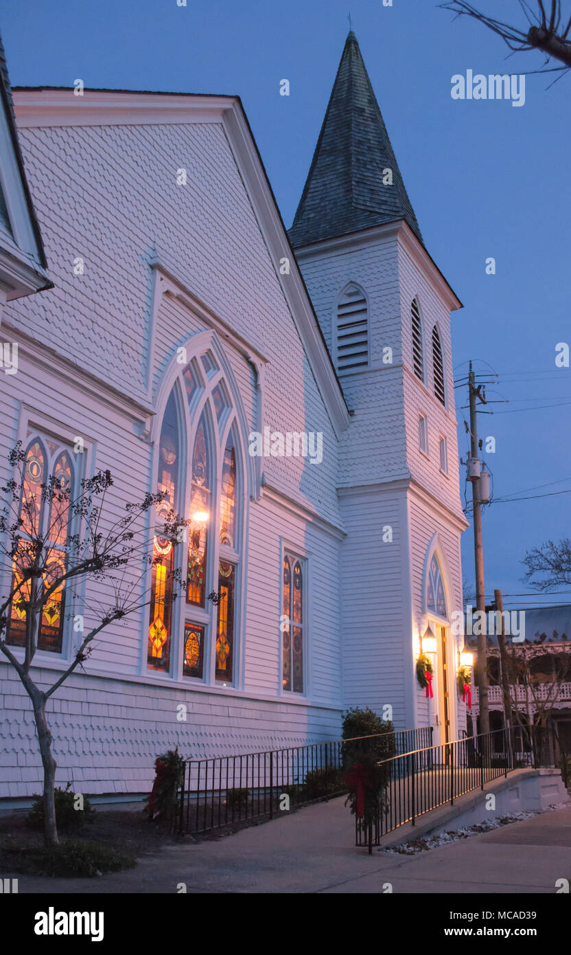 Church at dusk in historic Beaufort, NC stained glass windows catch