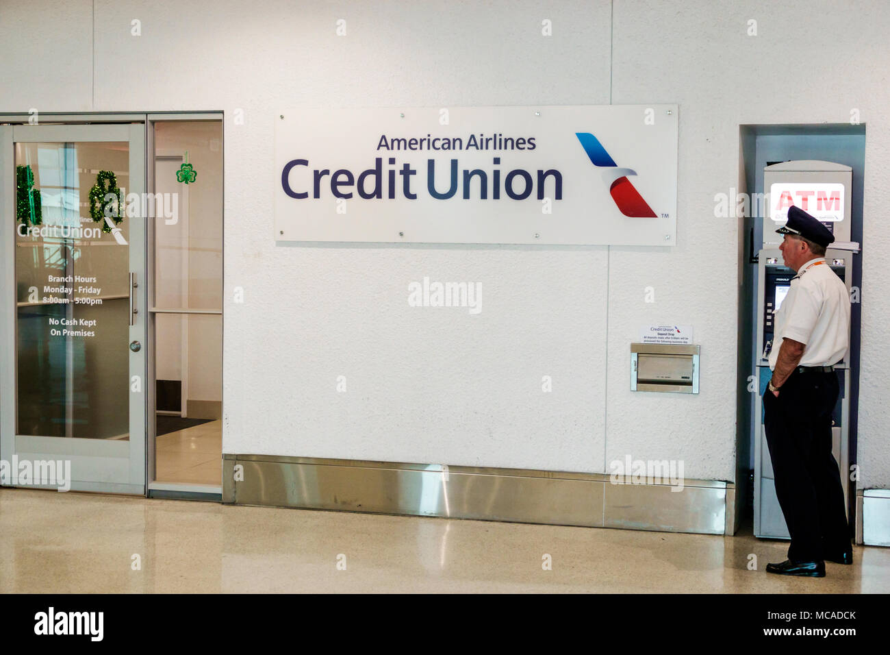 Miami Florida,International Airport MIA,terminal,D,American Airlines Credit Union,employee employees worker workers facility,ATM machine,man men male, Stock Photo