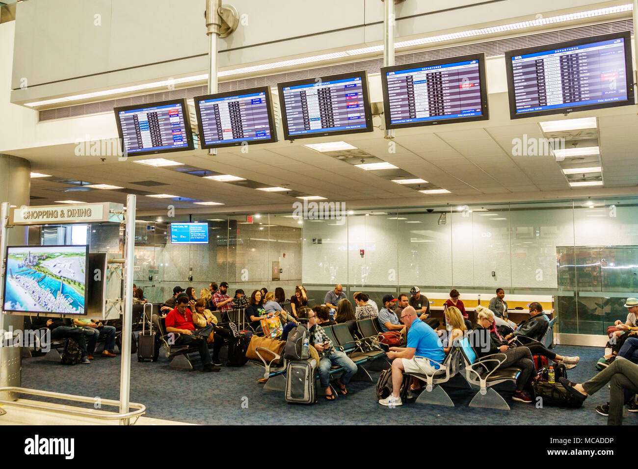 Miami Florida,International Airport MIA,terminal,D,gate,flight information  display system,FIDS,seating,man men male,woman female women,passenger passe  Stock Photo - Alamy
