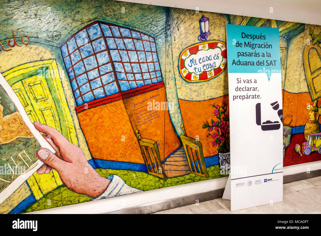 Mexico City,Mexican,Hispanic Latin Latino ethnic minority,Benito Juarez International Airport MEX,immigration,sign,Spanish language,mural,visitors tra Stock Photo