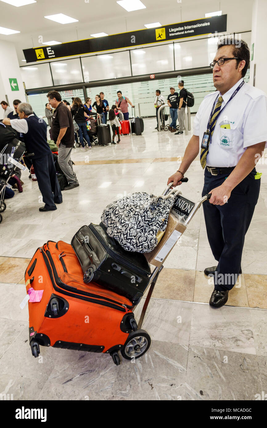 Mexico City,Mexican,Hispanic Latin Latino ethnic minority,Benito Juarez International Airport MEX,terminal,baggage luggage claim,cart,adult adults man Stock Photo