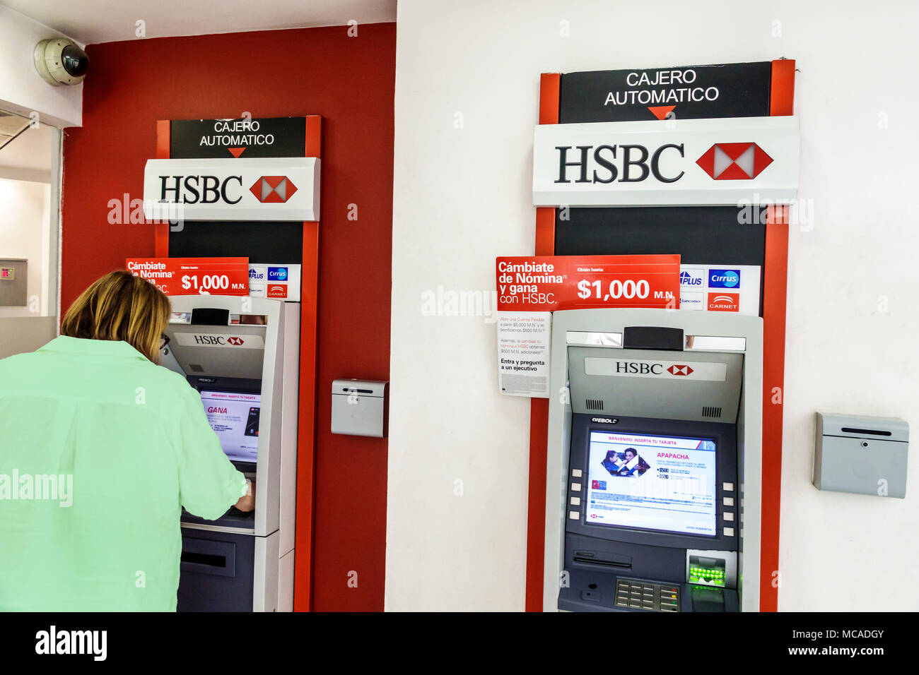 Mexico City,Mexican,Hispanic,Benito Juarez International Airport MEX,terminal,HSBC Bank,ATM,automatic teller machine,woman female women,Spanish langua Stock Photo