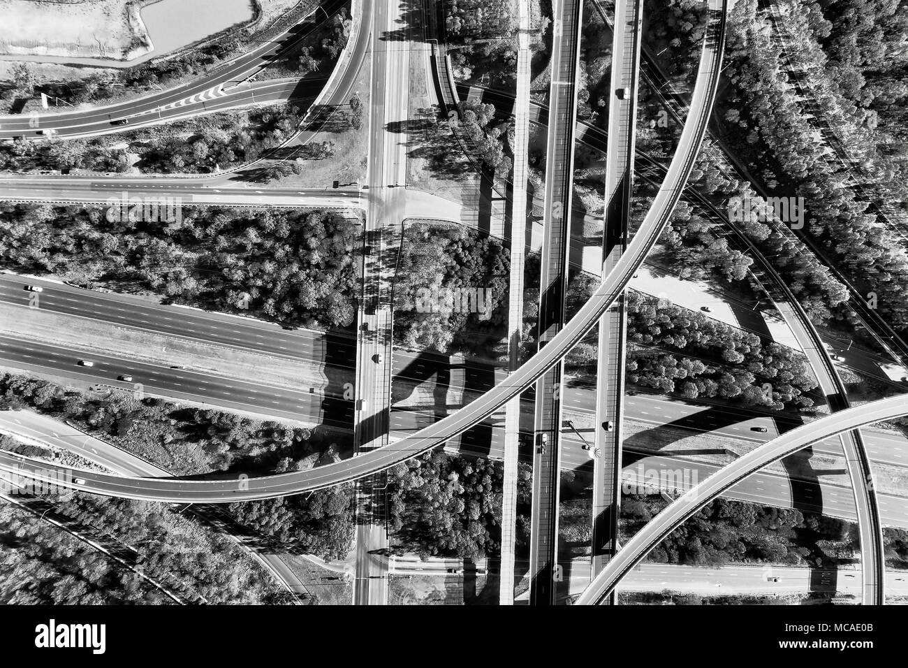 Light horse interchange between M4 and M7 motorways in Sydney west - the lagest in New South Wales and Greater Sydney. Aerial black white top down vie Stock Photo