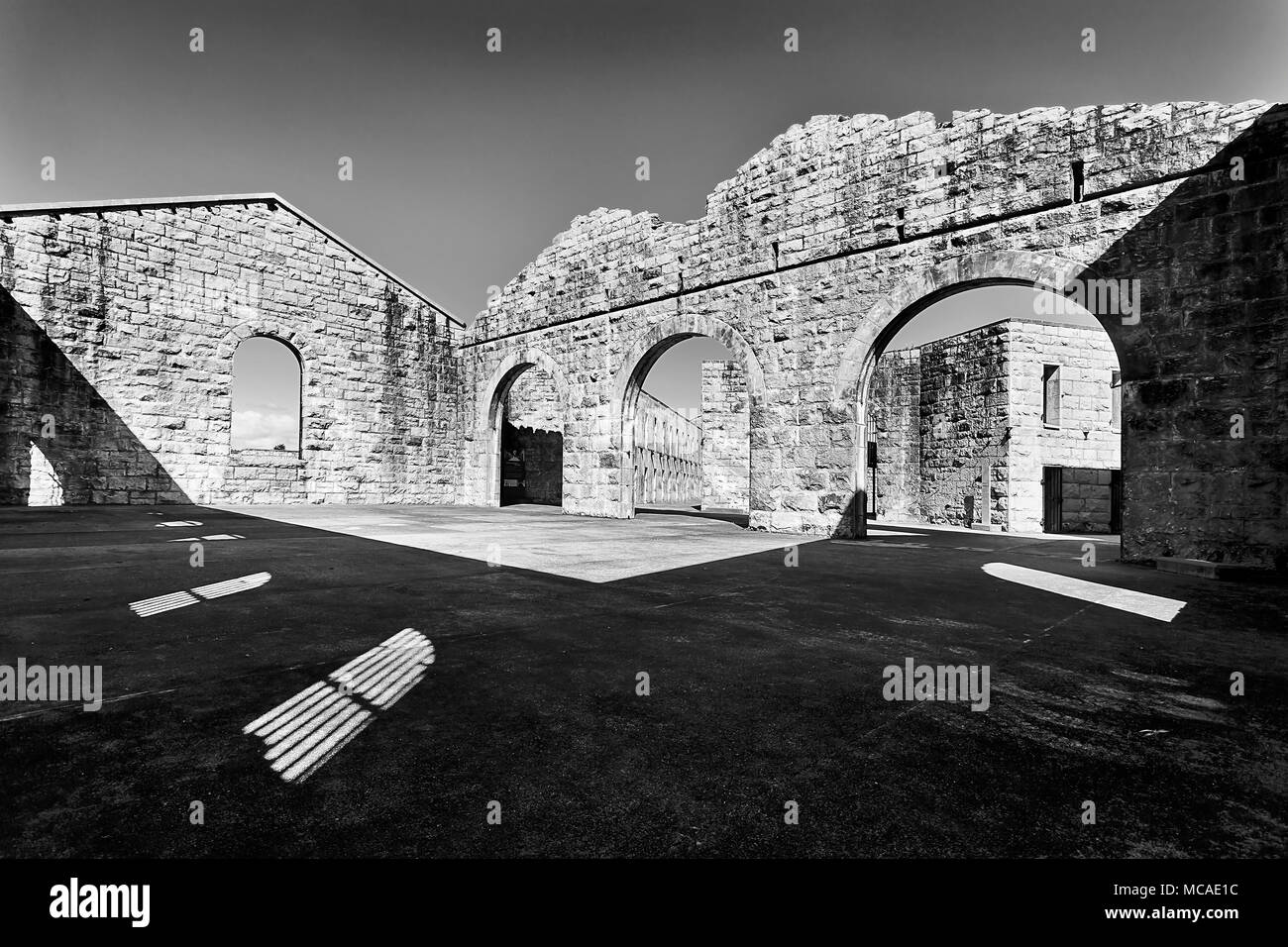 Inner yard of stone with brick walls but no roof in historic heritage Trial Bay Gaol of NSW of Australia. Contrast black-white impression of correctio Stock Photo