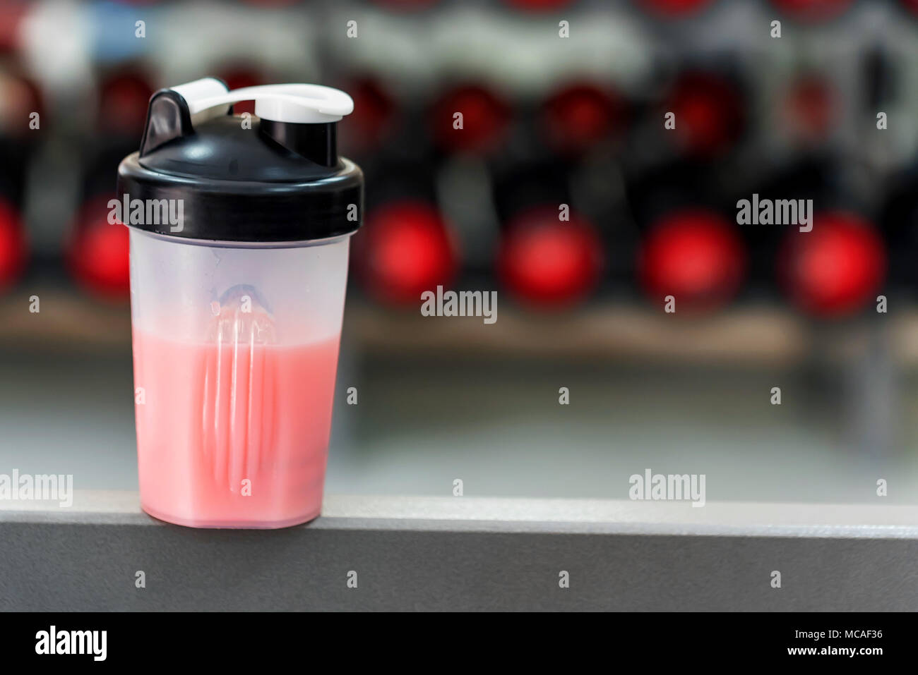 Plastic shaker with fitness cocktail in gym Stock Photo - Alamy