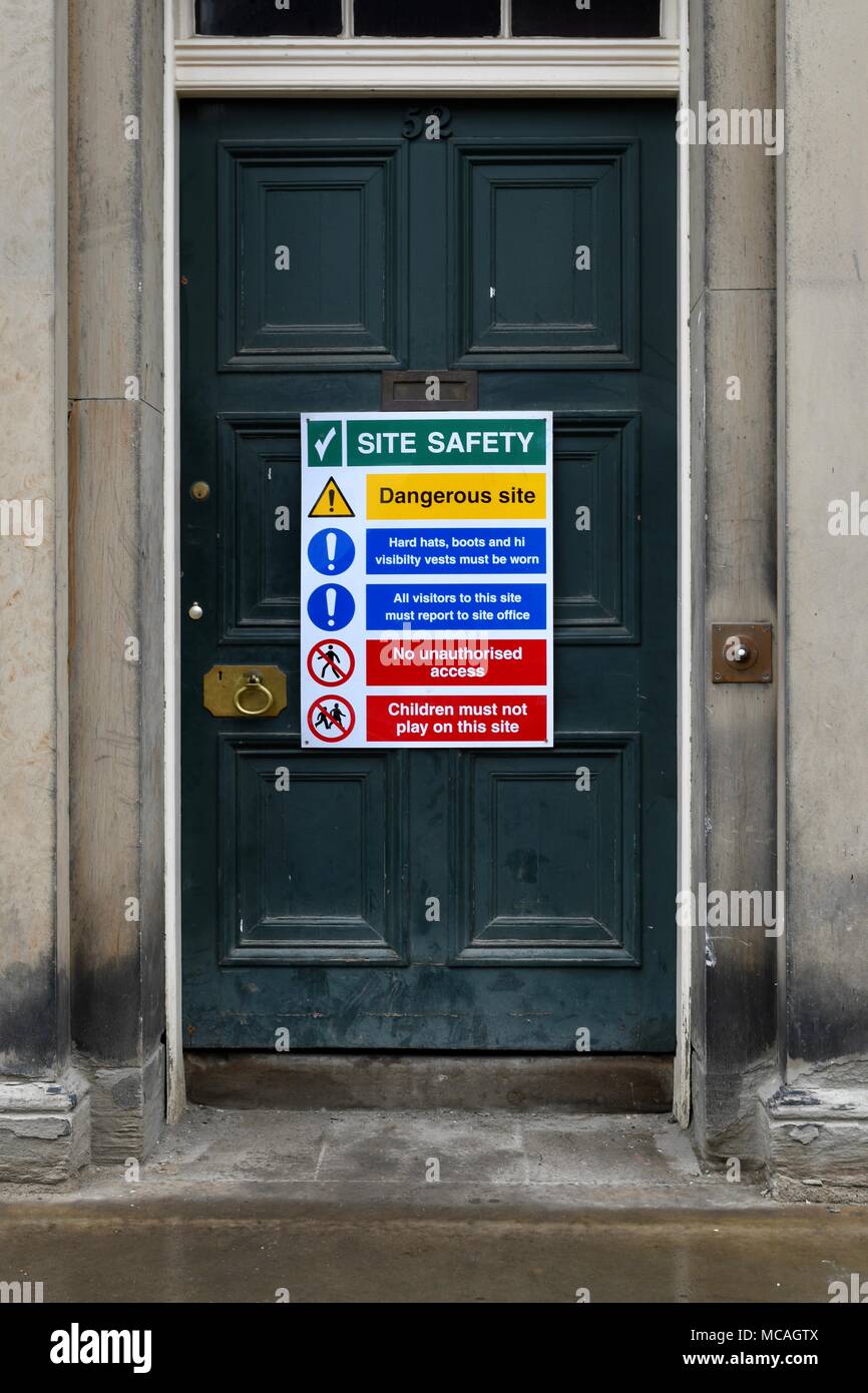 Safety sign on green door in Durham Stock Photo