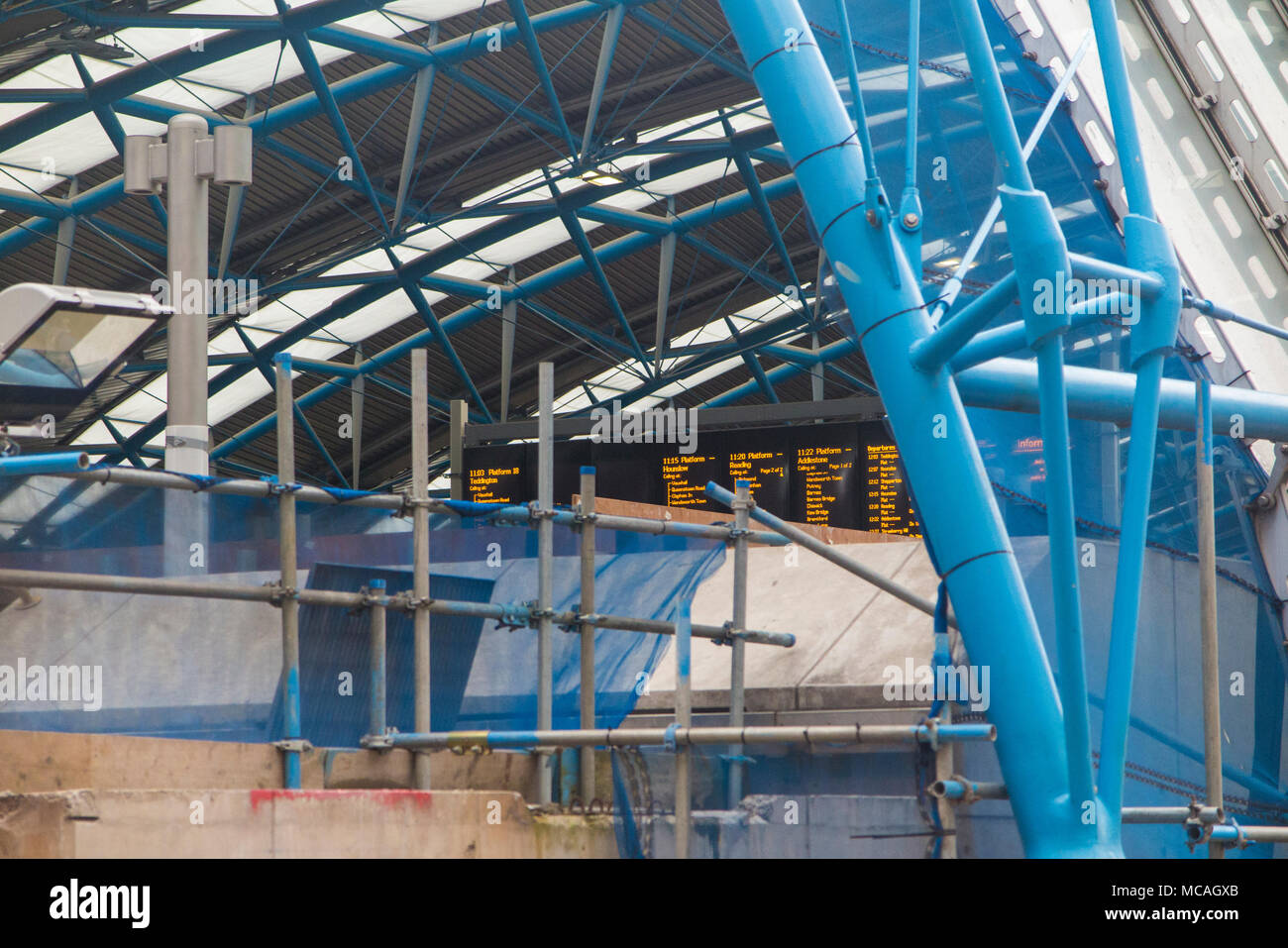 Work continues on the Waterloo International station conversion, with scaffolding and work but platforms and train displays fully operational Stock Photo