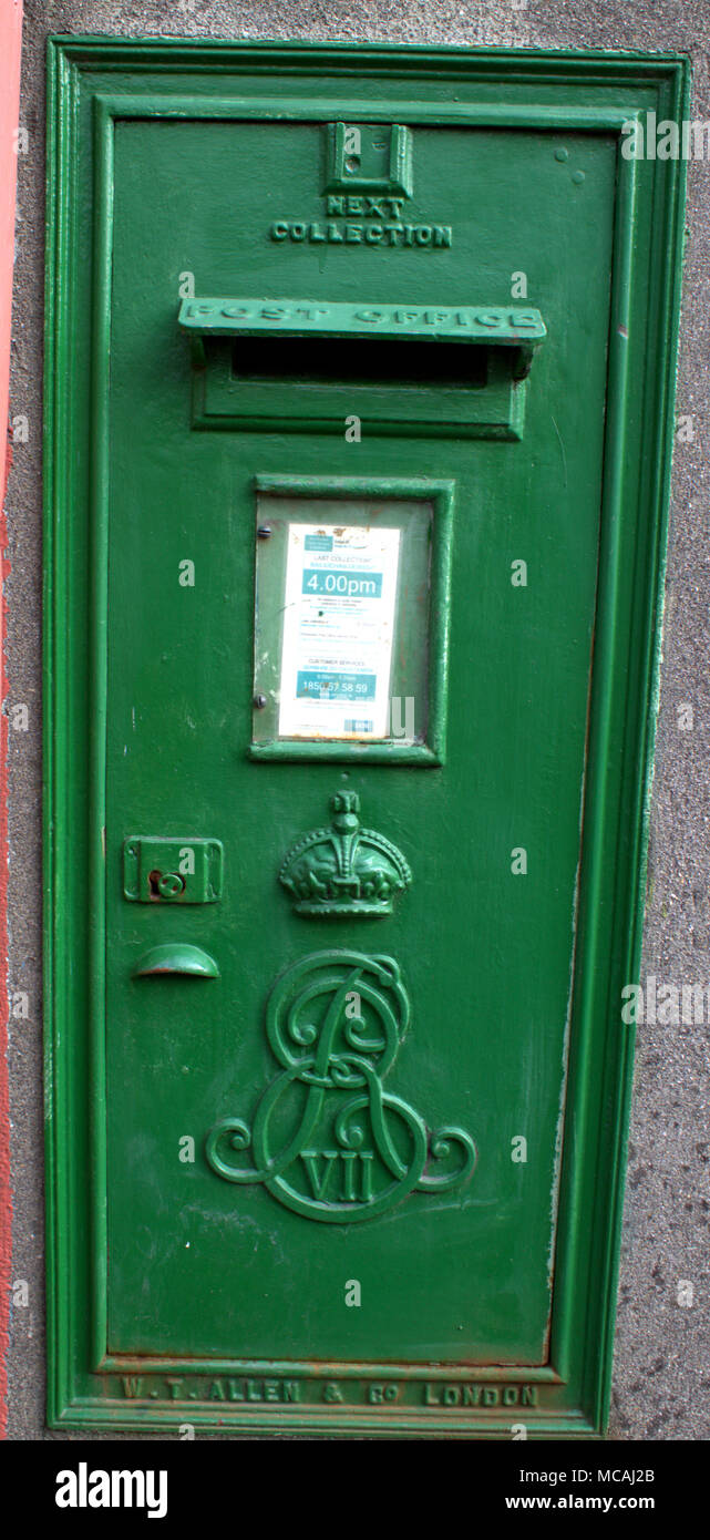 Irish cast iron green post box in ireland with the edward V11 emblem on the front, original colour, color would have been red before the free state. Stock Photo