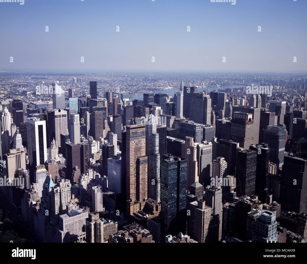 New York has architecturally significant buildings in a wide range of styles spanning distinct historical and cultural periods. These include the Woolworth Building (1913), an early Gothic revival skyscraper with large-scale gothic architectural detail. The 1916 Zoning Resolution required setback in new buildings, and restricted towers to a percentage of the lot size, to allow sunlight to reach the streets below. The Art Deco design of the Chrysler Building (1930) and Empire State Building (1931), with their tapered tops and steel spires, reflected the zoning requirements. The Chrysler buildin Stock Photo