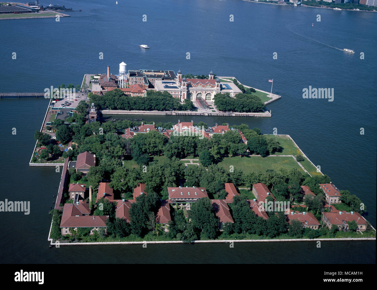 Ellis Island, in Upper New York Bay, was the gateway for millions of immigrants to the United States as the nation's busiest immigrant inspection station from 1892 until 1954. The island was greatly expanded with land reclamation between 1892 and 1934. Before that, the much smaller original island was the site of Fort Gibson and later a naval magazine. The island was made part of the Statue of Liberty National Monument in 1965, and has hosted a museum of immigration since 1990. Long considered part of New York, a 1998 United States Supreme Court decision found that most of the island is in New Stock Photo