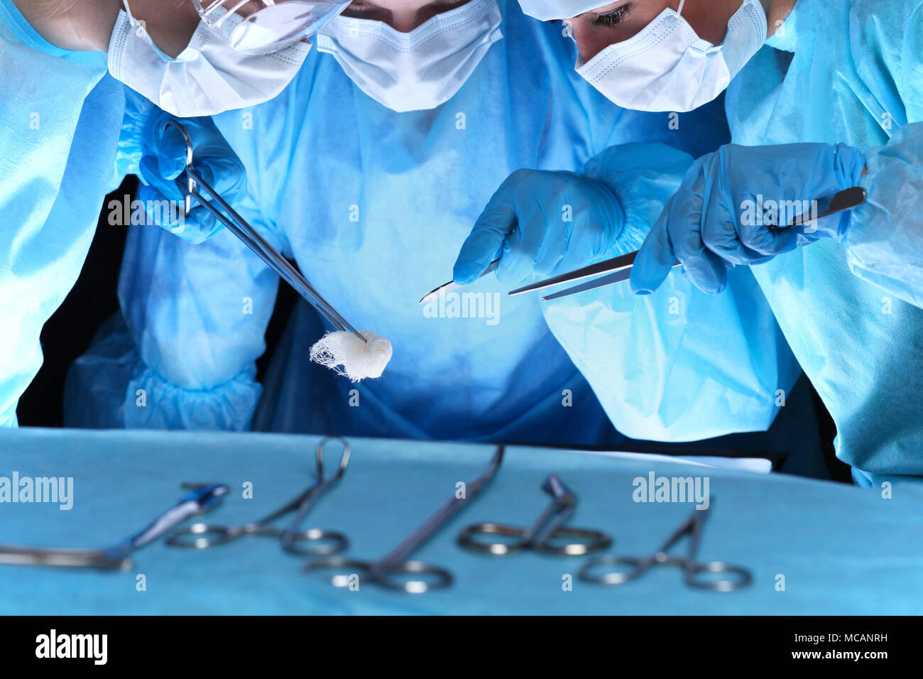 Group of surgeons in masks performing operation. Medicine, surgery and ...