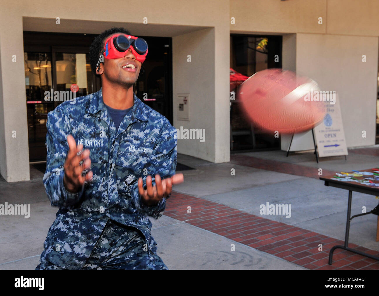 180201-N-PN275-1056 SAN DIEGO (Feb. 1, 2018) Hospital Corpsman Seaman Apprentice Tremaini Hendricks, assigned to Naval Medical Center San Diego (NMCSD), attempts to catch a football while wearing drunk goggles at NMCSD’s Drug and Alcohol Programs Advisor (DAPA) event. The DAPA event is designed to promote safe decision making and inform Sailors of the dangers of drug and alcohol abuse. ( U.S. Navy photo by Mass Communication Specialist 2nd Class Zachary Kreitzer) Stock Photo