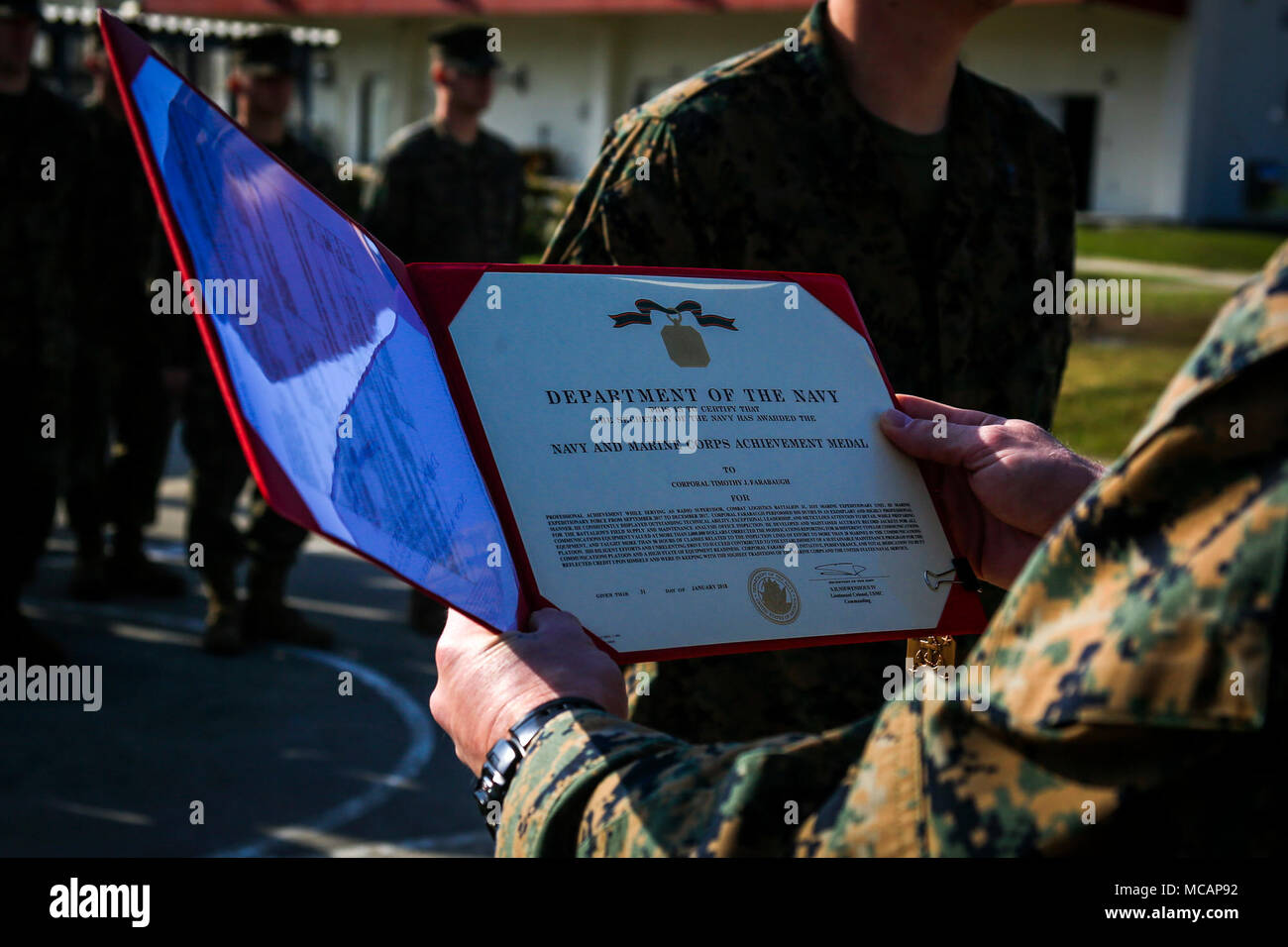Sgt Maj Christopher Gasser Sergeant Major Of Combat Logistics Battalion 31 31st Marine Expeditionary Unit Reads A Navy And Marine Corps Achievement Medal Citation For Cpl Timothy Farabaugh At Camp Hansen Okinawa