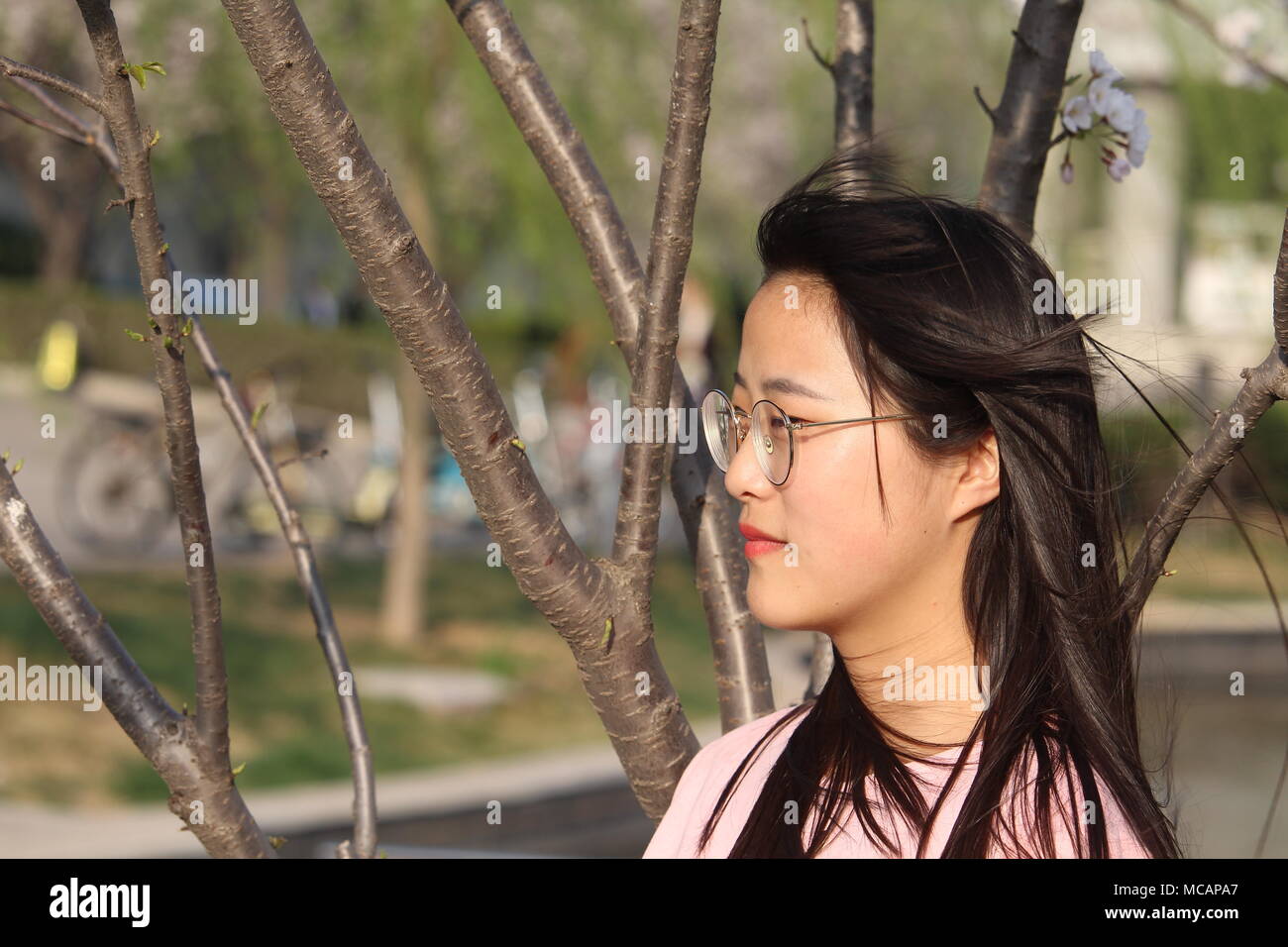 Beautiful Chinese girl enjoying photography in spring Stock Photo