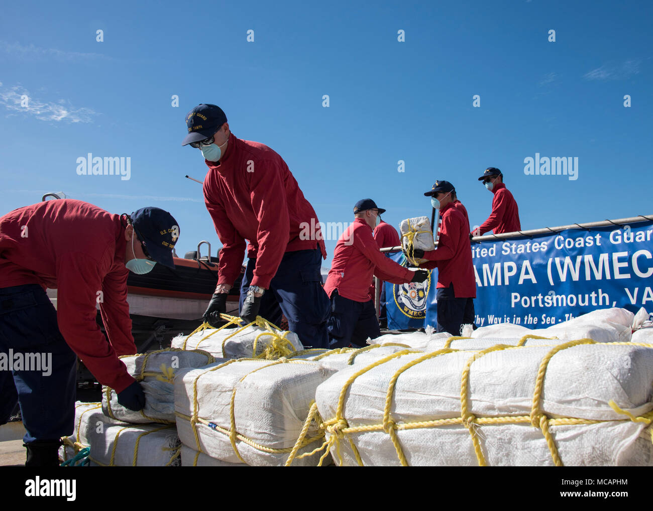 The crew of the Coast Guard Cutter Tampa, a 270-foot Medium Endurance Cutter based out of  Portsmouth, Va., offloads nearly two tons of cocaine Friday, Feb. 2, 2018, in St. Petersburg, Florida. While patrolling the Caribbean Sea in support of Operation Unified Resolve and Operation Martillo, approximately 1,580 kgs of cocaine were seized by the U.S. Coast Guard and partner nation crews between Dec. 20-22, 2017. (U.S. Coast Guard photo by Petty Officer 1st Class Michael De Nyse) Stock Photo