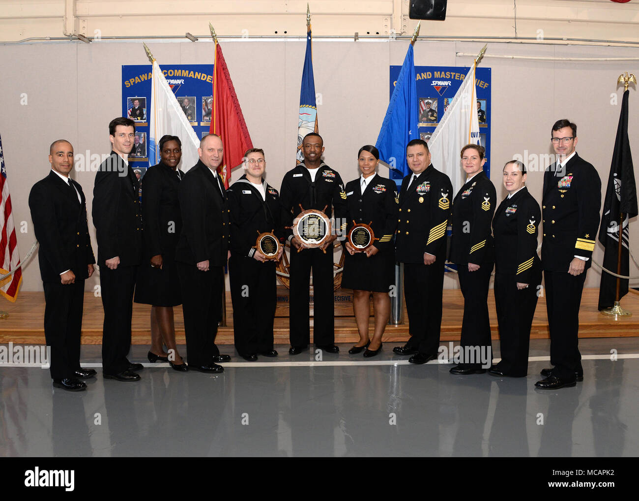 180202-N-UN340-005 SAN DIEGO (Feb. 2, 2018) Rear Adm. Christian 'Boris' Becker, right, commander, Space and Naval Warfare Systems Command (SPAWAR), SPAWAR Command Master Chief Pablo Cintron, left, and members of the SPAWAR Chief Petty Officers Mess pictured with the 2017 SPAWAR Sailor of the Year Logistics Specialist 1st Class John Myers, center.  Also pictured are SOY candidates Aviation Maintenance Administrationman 1st Class Yanda-Kalie Edwards and Information Systems Technician 1st Class Ryan Bertie.  (U.S. Navy photo by Rick Naystatt/Released) Stock Photo