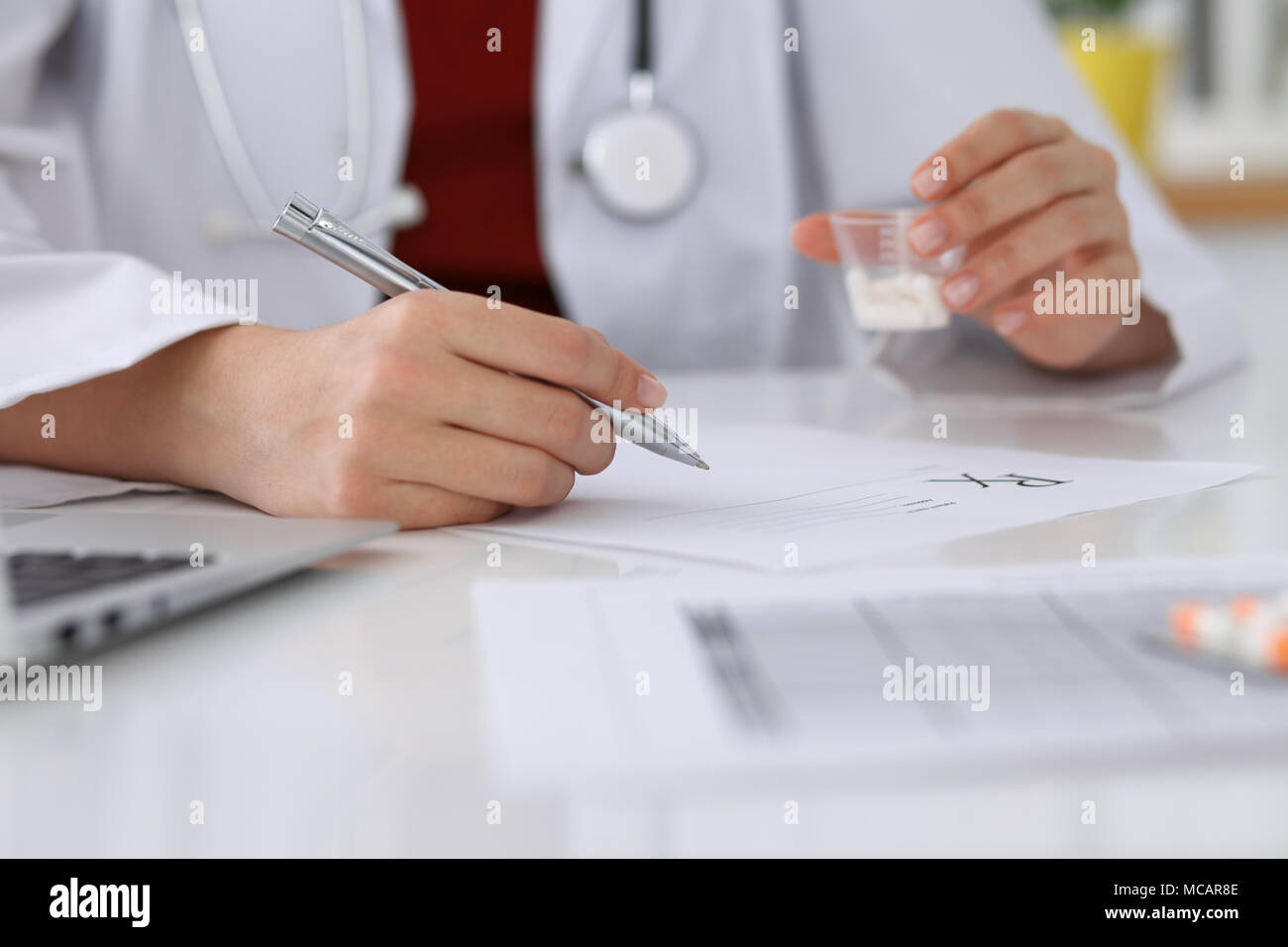 Female fills form prescription ... to doctor patient up medicine