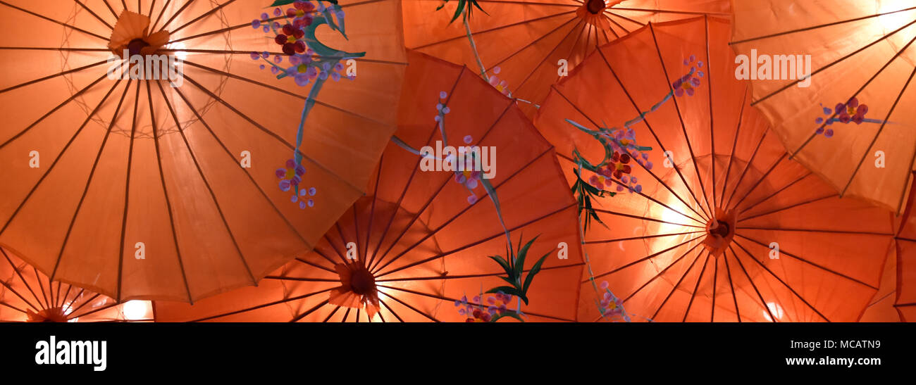 Oriental Chinese sun shade umbrellas with attractive design on a red