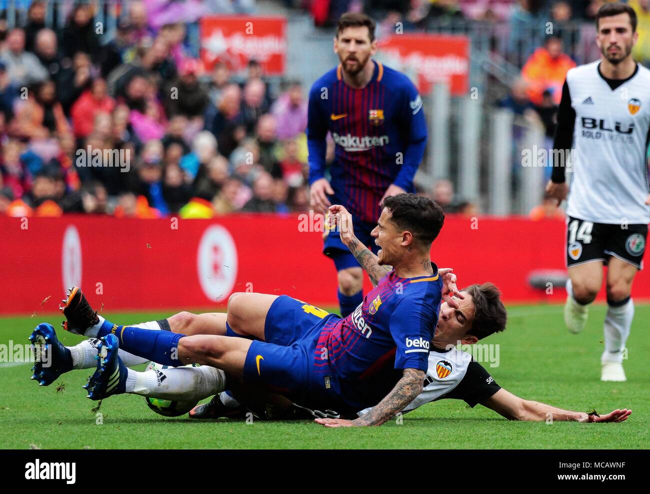 Barcelona, Spain. 14th Apr, 2018. Barcelona's Philippe Coutinho (Front) vies with Valencia's Gabriel Paulista (Bottom) during a Spanish league soccer match between Barcelona and Valencia in Barcelona, Spain, on April 14, 2018. Barcelona won 2-1. Credit: Joan Gosa/Xinhua/Alamy Live News Stock Photo