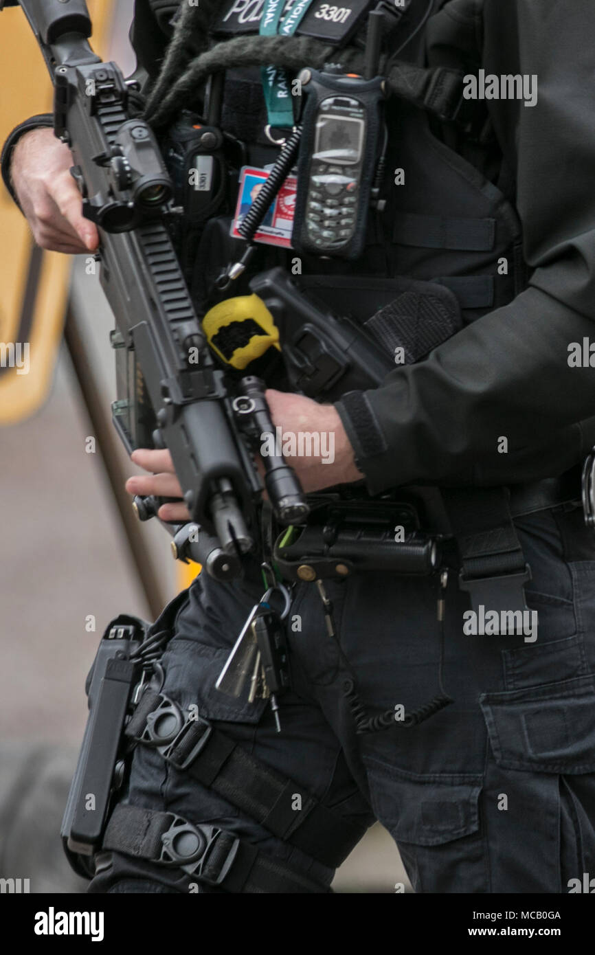 Uniformed Armed British Police, authorised firearms officer (AFO) a British police officer with gun, radio, taser, telephone, ID,  weapons & equipment Liverpool, Merseyside, UK. 14th April, 2018. Policing at the Grand National Meeting Aintree Racecourse. Stock Photo