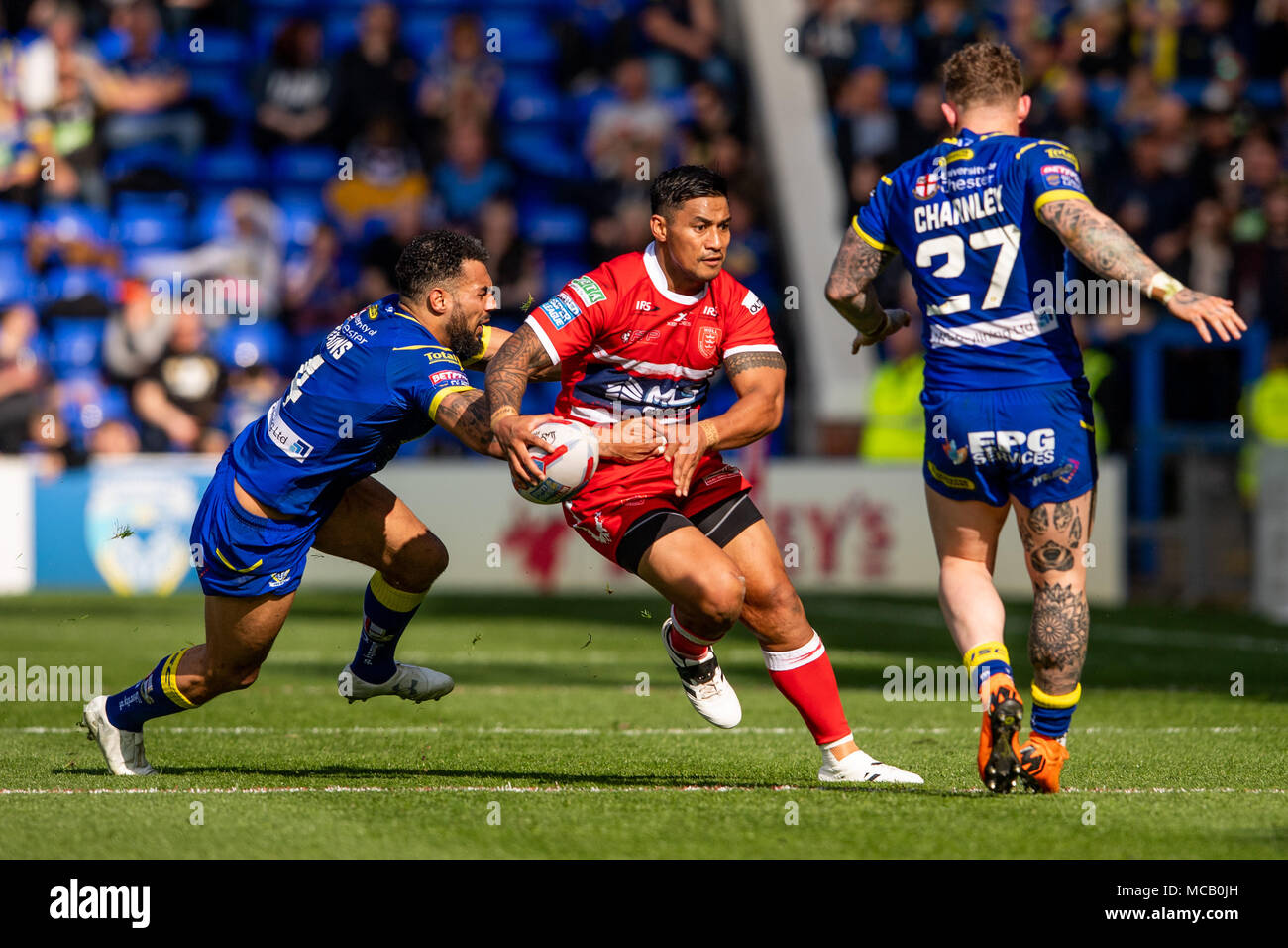 Hull's Taioalo Vaivai is tackled by Warrington Wolves's Ryan Atkins  14th April 2018 , The Halliwell Jones Stadium Mike Gregory Way, Warrington, WA2 7NE, England;  Betfred Super League rugby, Round 11, Warrington Wolves v Hull Kingston Rovers Stock Photo