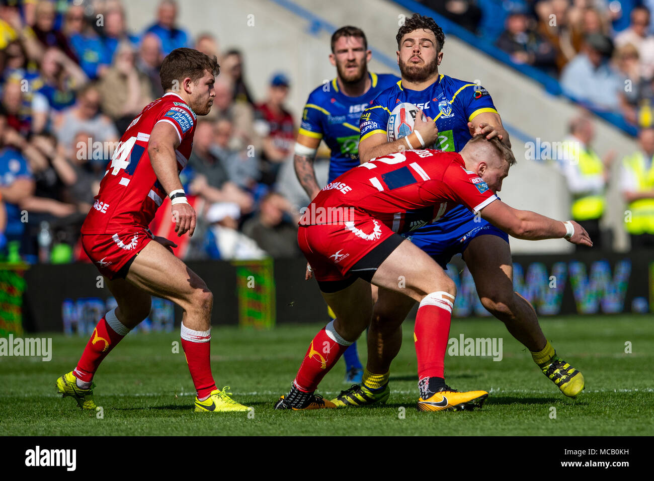 Warrington Wolves's Joe Philbin is tackled by  Hull's James Greenwood  14th April 2018 , The Halliwell Jones Stadium Mike Gregory Way, Warrington, WA2 7NE, England;  Betfred Super League rugby, Round 11, Warrington Wolves v Hull Kingston Rovers Stock Photo