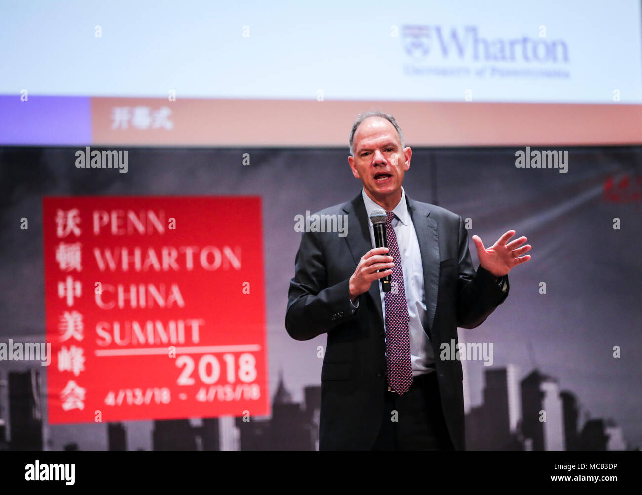 Philadelphia, USA. 14th Apr, 2018. Geoffrey Garrett, dean of the Wharton School at the University of Pennsylvania, delivers a speech during the opening ceremony of the Penn Wharton China Summit at the University of Pennsylvania in Philadelphia, Pennsylvania, the United States, April 14, 2018. The U.S. government should move beyond the traditional mindset of power politics to tackle challenges in China-U.S. relations, Fu Ying, a veteran Chinese diplomat, said here Saturday. Credit: Wang Ying/Xinhua/Alamy Live News Stock Photo