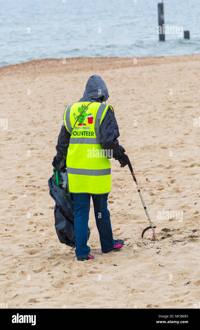 Bournemouth, Dorset, UK. 15th April 2018. Plastic Free Bournemouth hold their first community beach clean as part of Surfers against Sewage Spring Beach Clean. Volunteers take part in picking up litter between Boscombe Pier and Bournemouth Pier, despite the dreary weather with rain on its way. high visability clothing Credit: Carolyn Jenkins/Alamy Live News Stock Photo