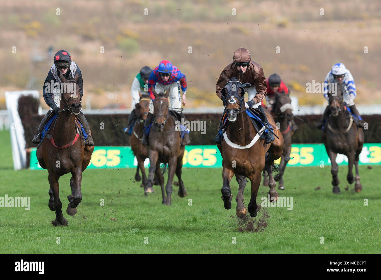 Ffos Las Racecourse, Trimsaran, Wales, UK. Sunday 15 April 2018. The Lion Dancer (jockey Gavin Sheehan) leads from Clondaw Rigger (jockey Ben Poste) (left)in the 3 M Handicap Chase Credit: Gruffydd Thomas/Alamy Live News Stock Photo