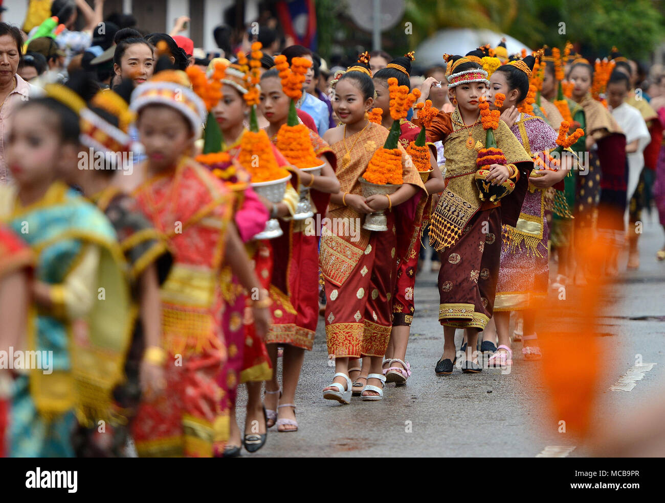 Luang Prabang, Laos. 15th Apr, 2018. People participate in a parade to