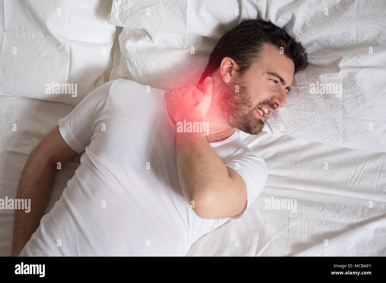Man suffering from neck ache on bed at bedroom Stock Photo Alamy