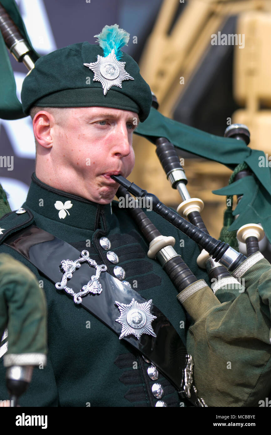 Uniformed musician of The Irish Guards or The Micks playing bagpipes