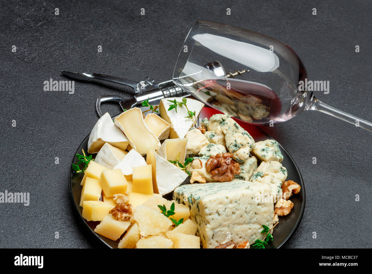 various types of cheese in dark plate Stock Photo