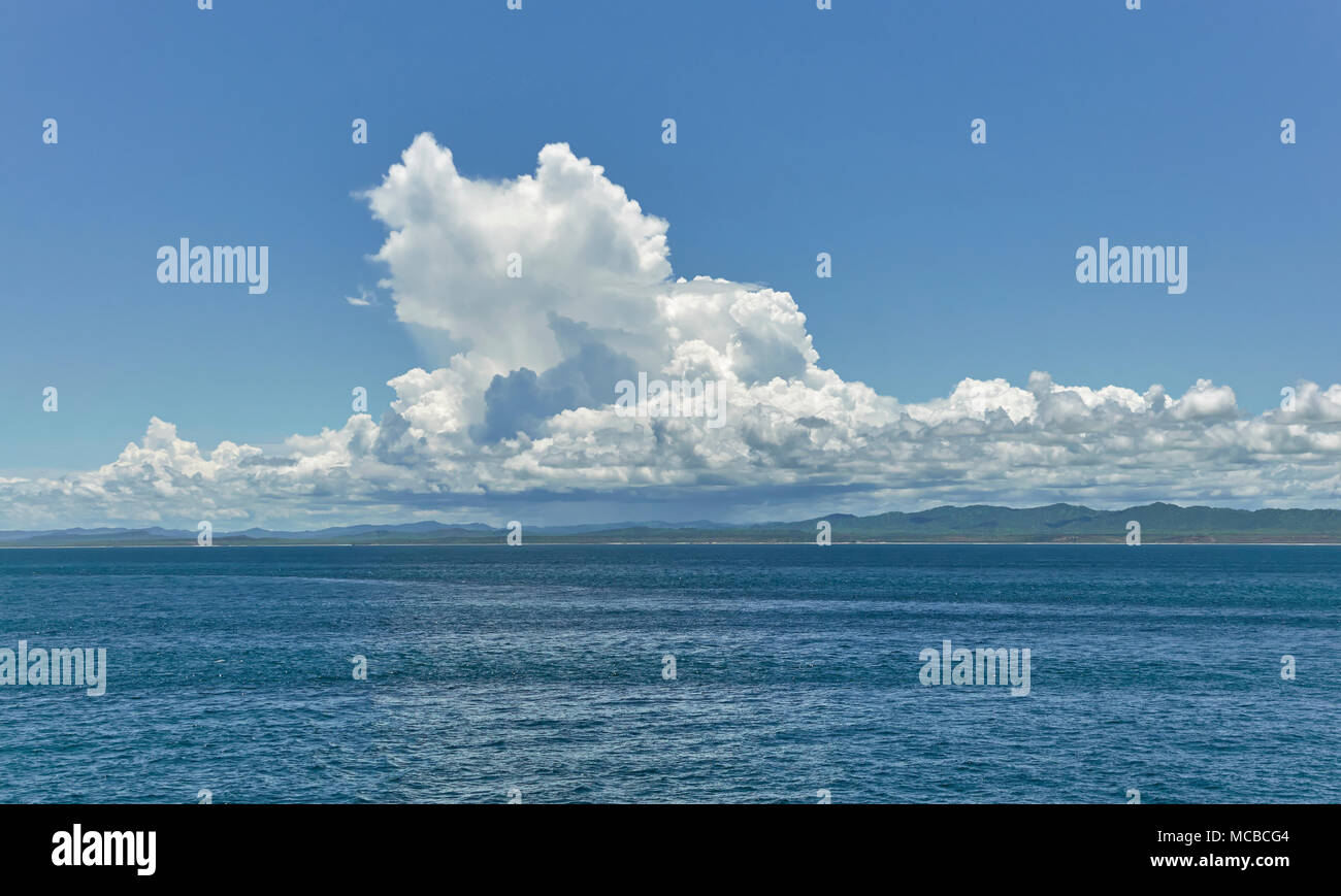 Billowing Cumulus onshore Clouds forming inland just off the coast of North East Peru one late afternoon near the Fishing town of Talara in Peru. Stock Photo