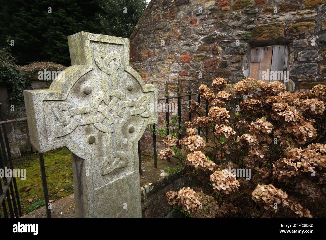 A cross in a celtic design in the grounds of cramond kirk in Edinburgh Stock Photo