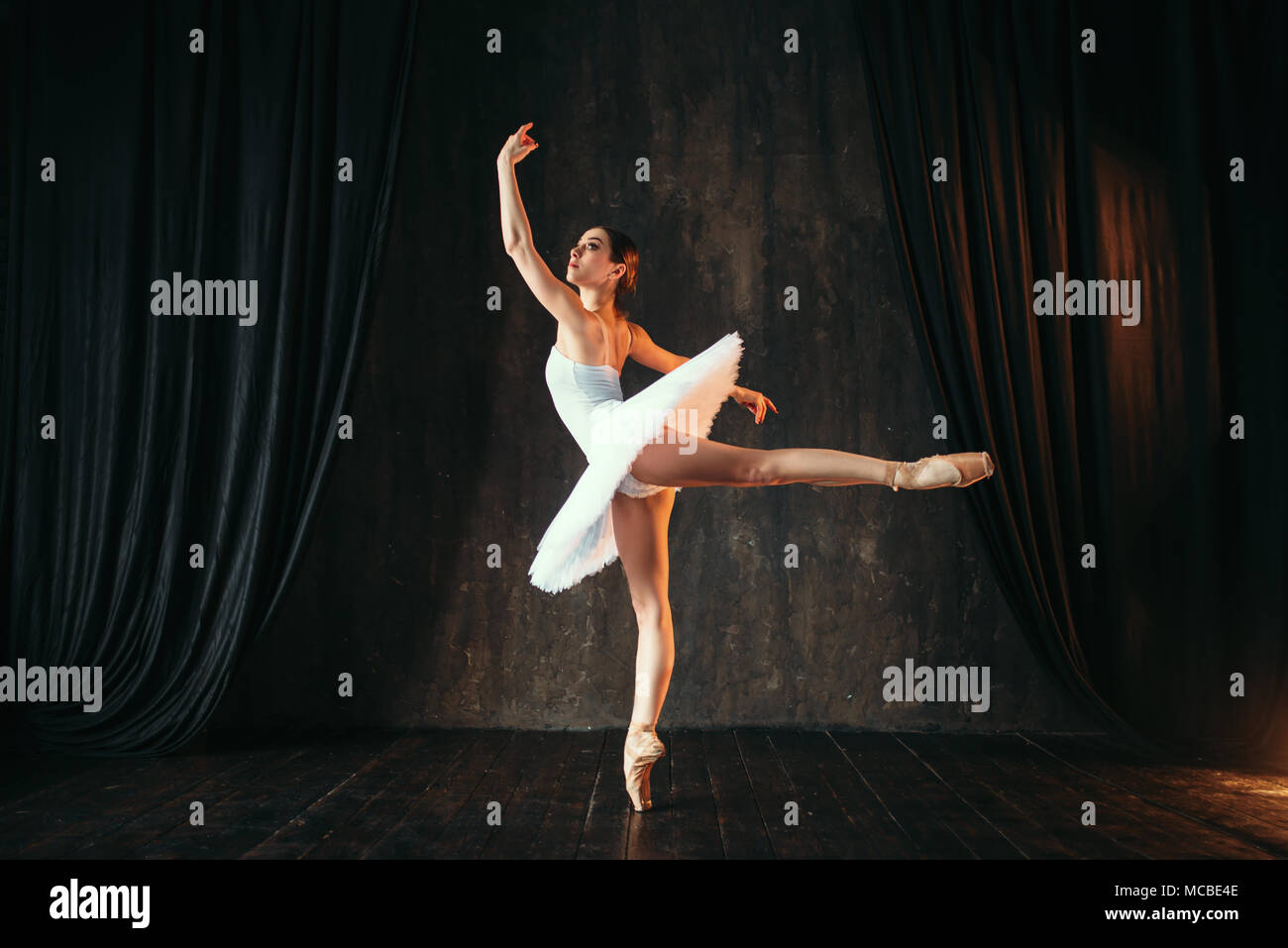 Ballerina in white dress dancing in ballet class Stock Photo