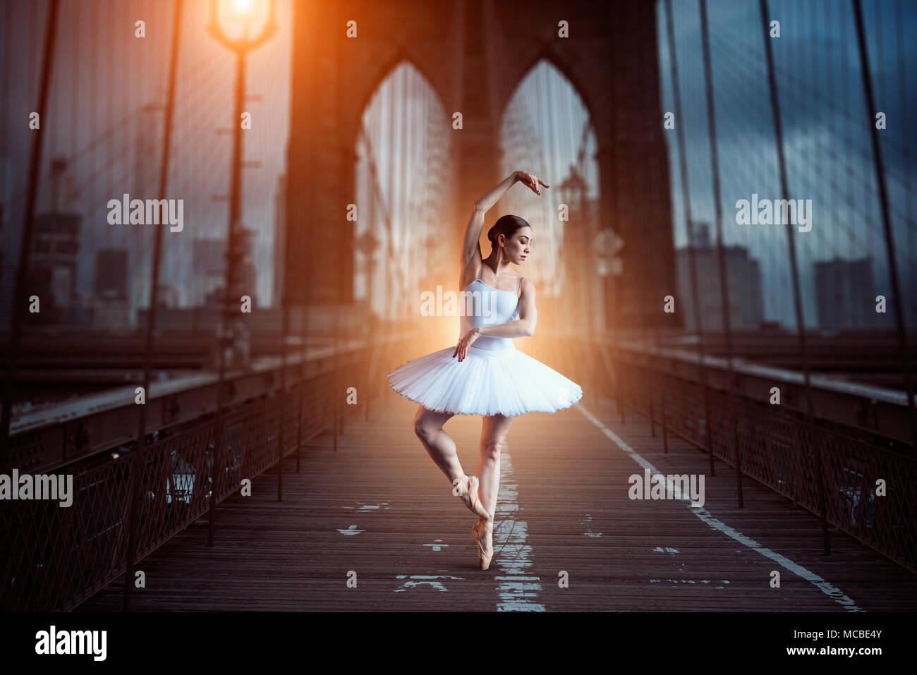 Ballet dancer dancing on the bridge in the evening Stock Photo