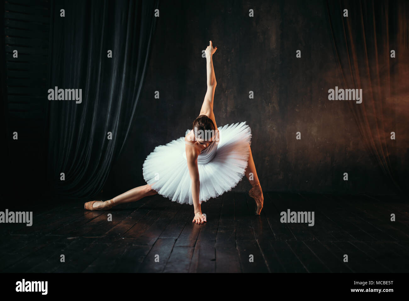 Grace of ballerina in motion on theatrical stage Stock Photo