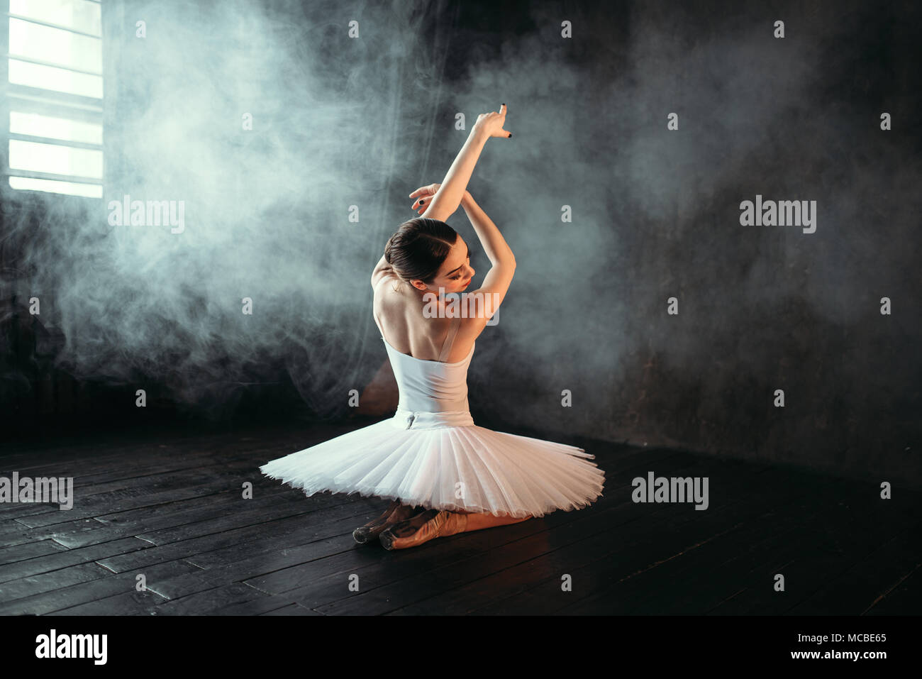Female classical ballet performer sitting on floor Stock Photo